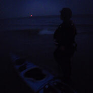 Paddlers land, full moon rises